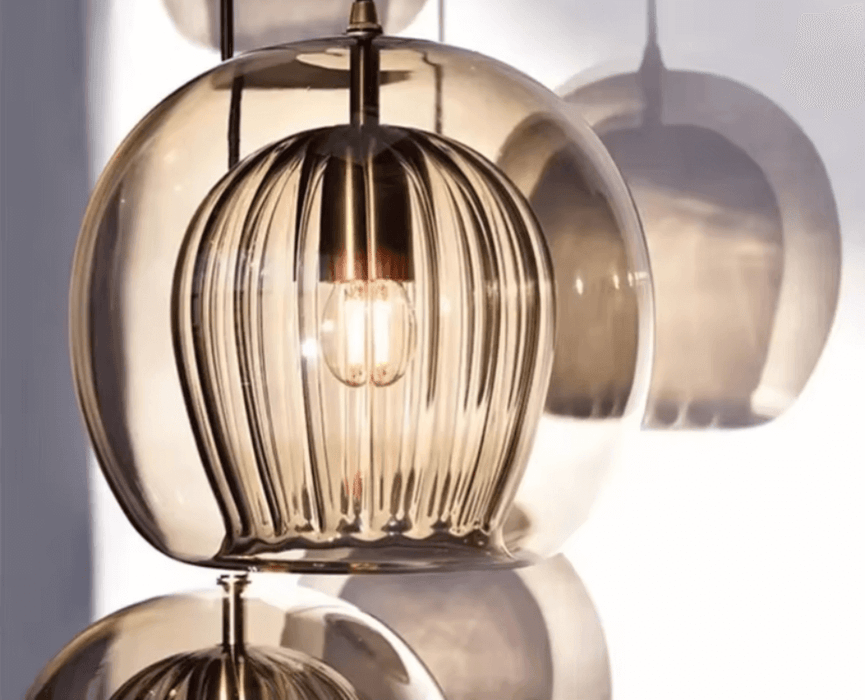 Modern glass double shade pendant light with warm glow, perfect for contemporary living rooms or dining areas.