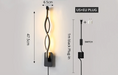 Modern artistic wall lamp with LED lighting, featuring elegant twisted design and USB plug, dimensions 47.5cm x 6.5cm.