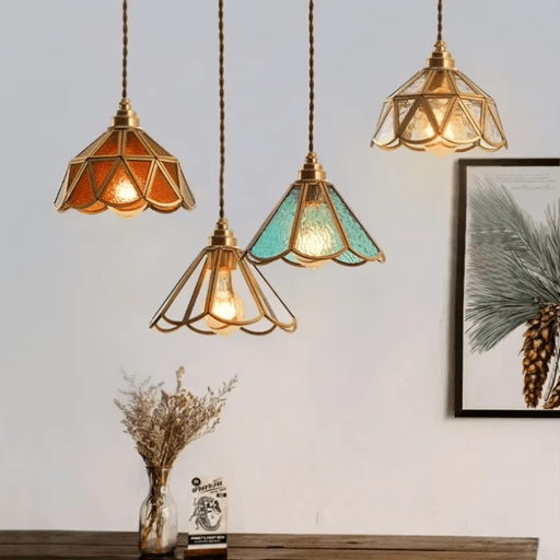 Vintage colored glass pendant lights with gold frames, ideal for cozy dining spaces and cafes, enhancing ambiance with vibrant design.