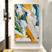 Bold abstract canvas art with vivid strokes in yellow, blue, and green hues, displayed in a modern hallway.