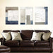 Modern abstract canvas art set with geometric patterns above a leather sofa, enhancing living room decor.