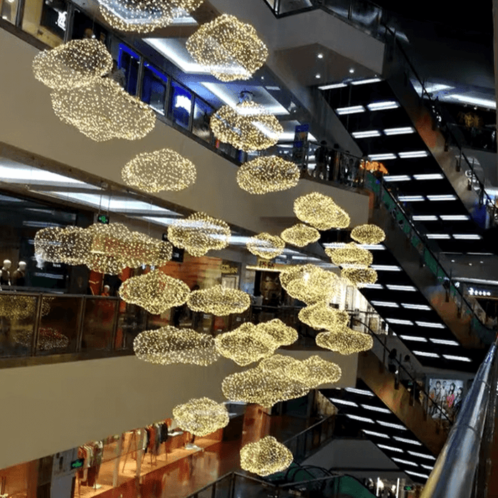 Cloud-Inspired Iron Net Chandeliers illuminating a modern shopping mall setting.