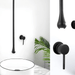 Ceiling-mounted water drop basin faucet in matte black finish above a white sink with a minimalist design and lush green plant.