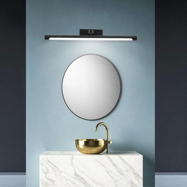 Modern bathroom with a Sleek LED Vanity Mirror Light, round mirror, and gold sink on a marble countertop against a blue wall.