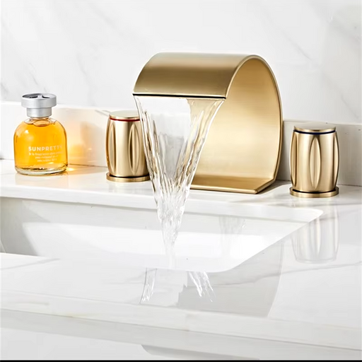 Elegant brass wave shape waterfall basin faucet set in modern bathroom sink.