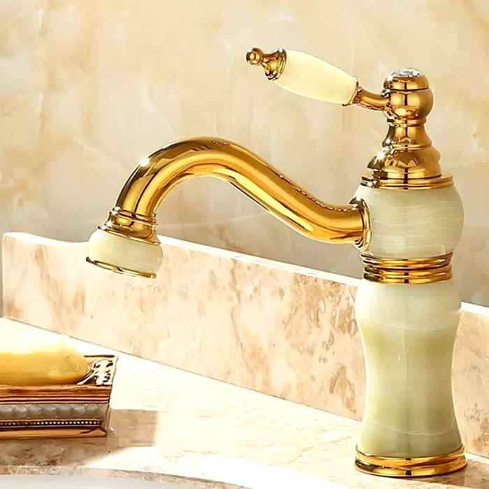 Luxury brass and jade basin faucet with gold finish adds elegance to bathroom decor.