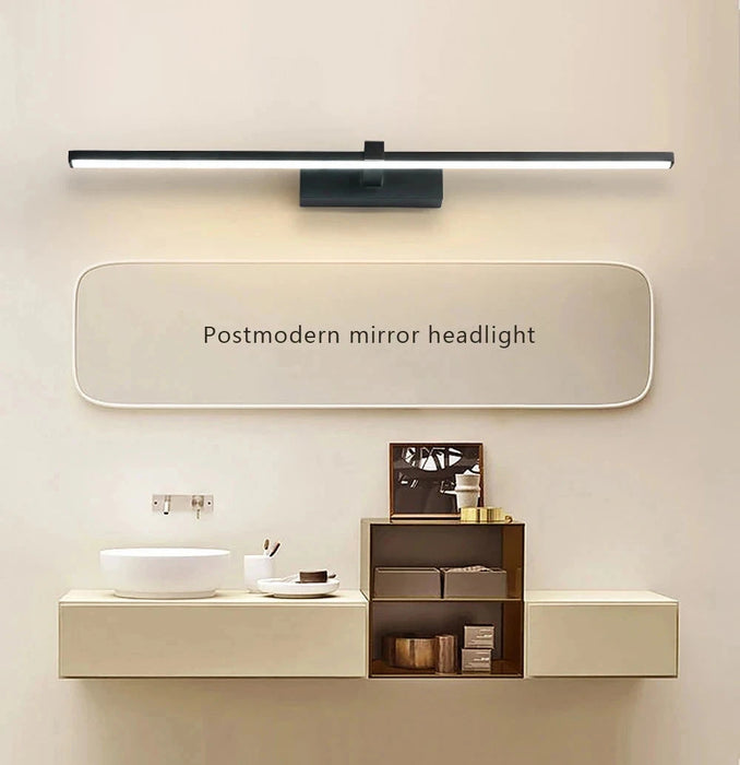 Modern LED aluminum wall light above bathroom vanity with mirror.