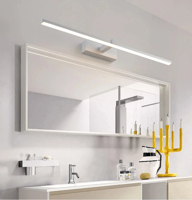 Modern bathroom with Sophia LED wall light illuminating a large mirror, featuring sleek aluminum design and contemporary decor.