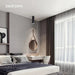 Elegant bedroom with modern decor, featuring a stylish pendant light and natural light from large windows.