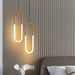 Modern minimalist U-shaped bar chandelier in polished chrome, LED lighting for parlor or bedroom, creates elegant atmosphere.