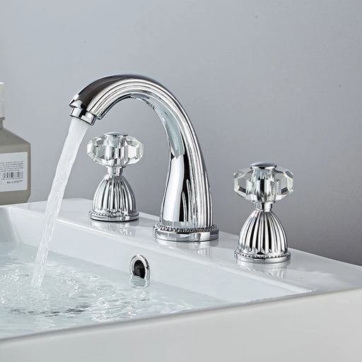 Elegant widespread basin mixer faucet with antique charm and dual handles, flowing water into a white sink.