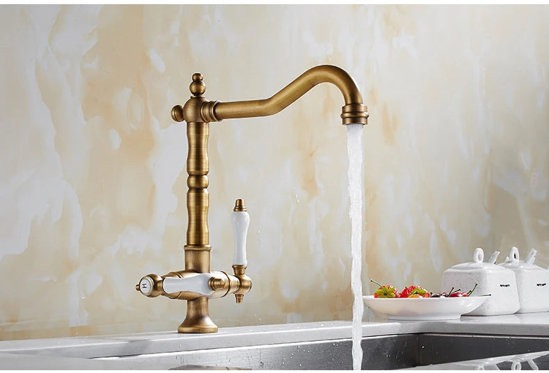 Antique bronze dual handle kitchen faucet mixer with flowing water, durable brass construction, single hole deck mounted installation.