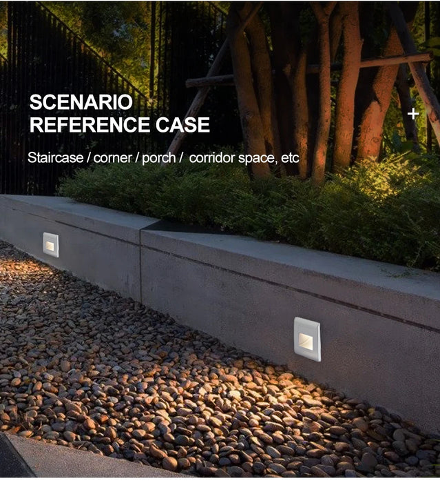 Recessed LED wall lamps with motion sensors illuminating an outdoor pathway at night.