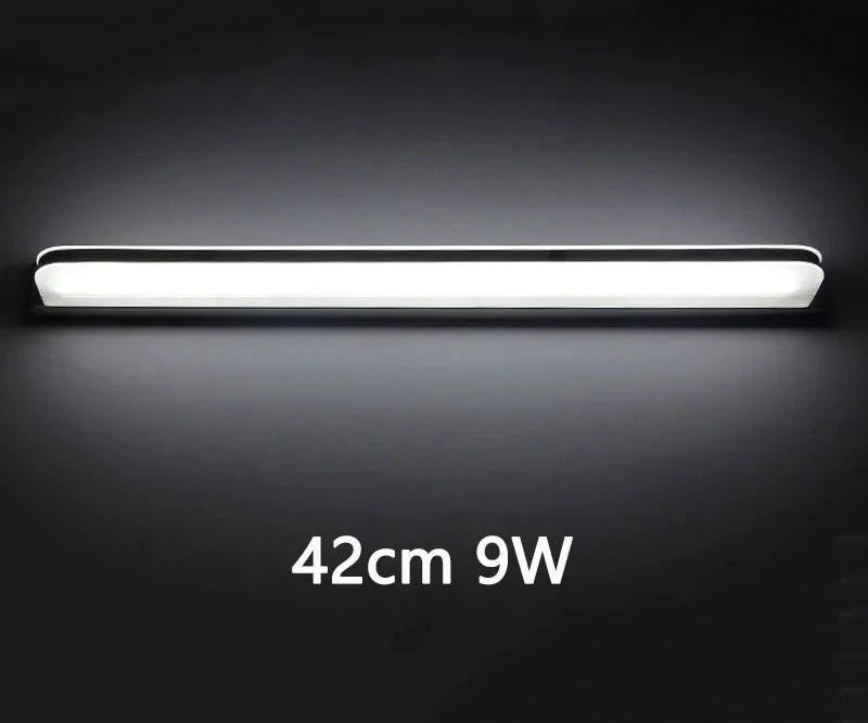 Stainless steel mirror light, 42 cm length, 9W power, shown illuminated against a dark background.