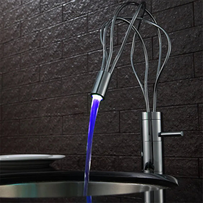 Modern LED deck-mount basin faucet with illuminated water flow in contemporary bathroom setting