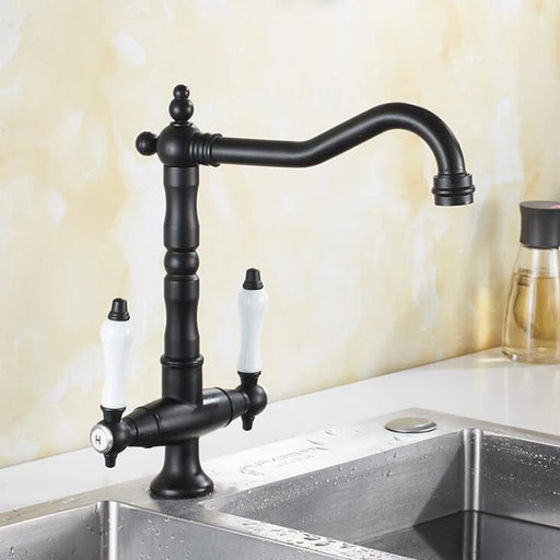 Antique bronze dual handle kitchen faucet mixer with hot and cold water control in a modern kitchen setting.