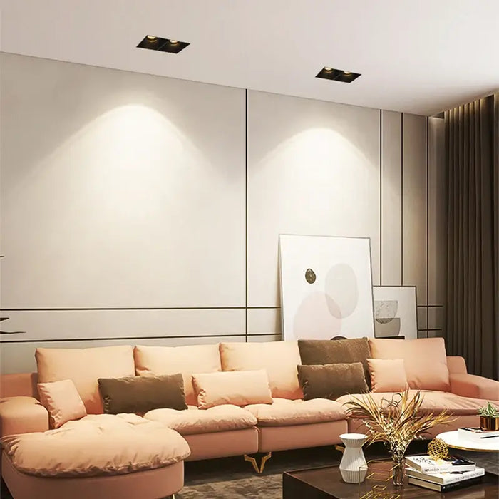 Modern living room with frameless LED recessed downlight spotlights illuminating a stylish interior design.