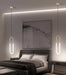 Minimalist U-shaped bar chandelier in modern bedroom setting with polished chrome finish and LED lighting.