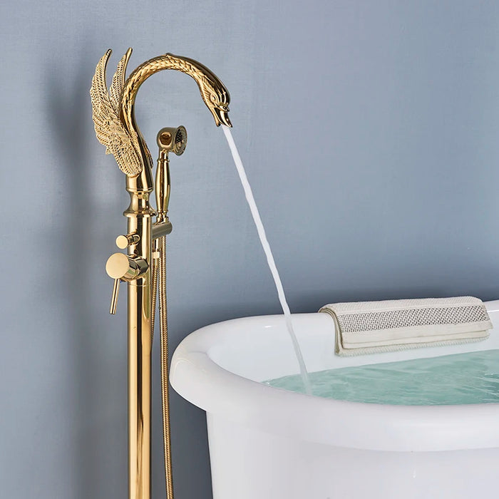 Luxury swan-style gold floor-standing bathtub faucet filling a white tub with water in a modern bathroom setting.