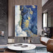 Abstract blue ocean oil painting in modern living room, vertical canvas on wall, hand-painted on premium linen, bold and timeless art.