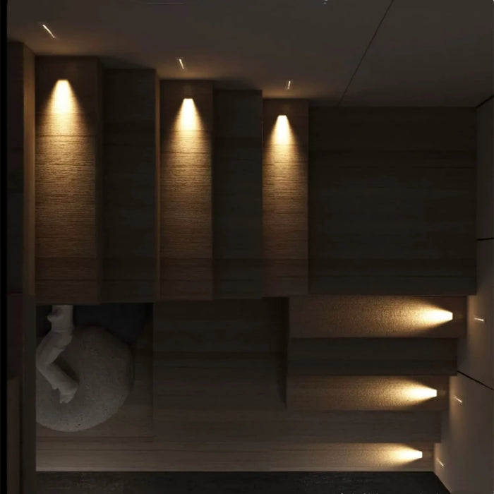 Modern indoor stairway illuminated by sleek wall lamps showcasing warm LED lighting, enhancing ambiance and safety.