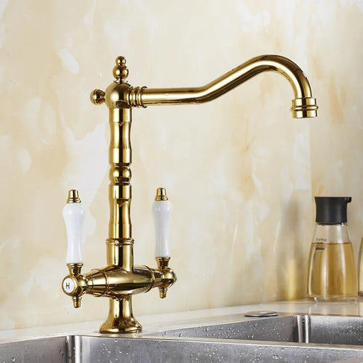 Antique bronze dual handle kitchen faucet mixer with hot and cold water control installed on a kitchen sink.