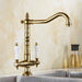 Antique bronze dual handle kitchen faucet mixer with hot and cold water control installed on a kitchen sink.