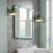 Modern industrial wall lamps with black finish illuminating a stylish bathroom with mosaic tiles and large mirror.