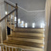 Modern LED recessed footlights illuminating a wooden staircase with brick walls, perfect for pathways and corridors.