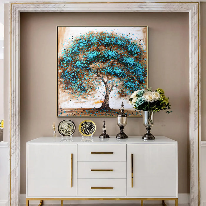 Hand-painted Tree of Life oil painting on canvas above white cabinet with decorative items in elegant room setting.