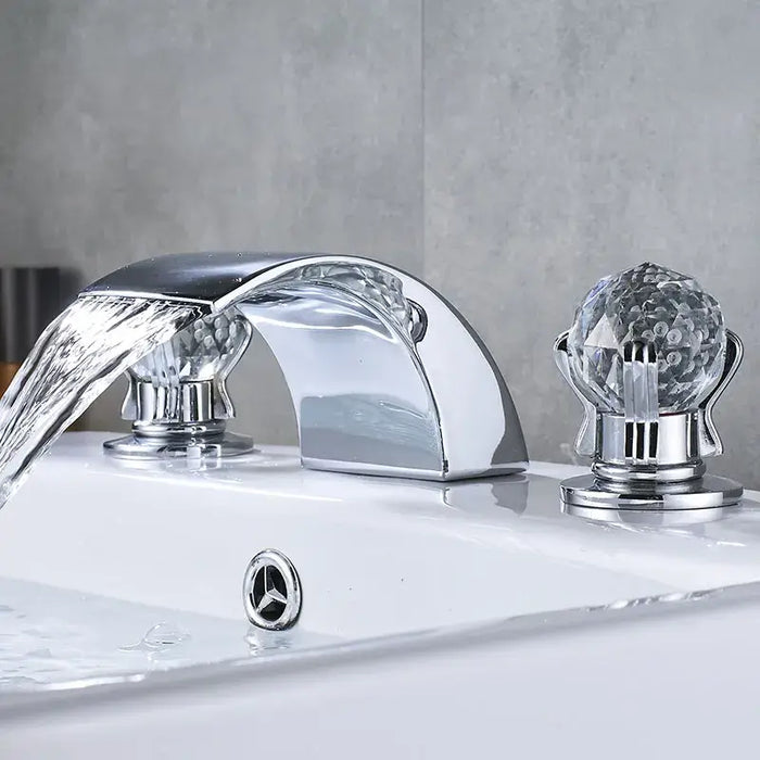 Crystal Handle Waterfall Faucet with polished chrome finish, featuring elegant design and smooth water flow in a modern bathroom setting.