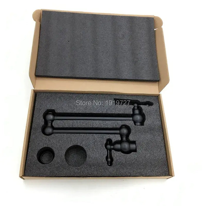 Foldable kitchen sink faucet in protective packaging inside an open box, showcasing its space-saving design and build quality.