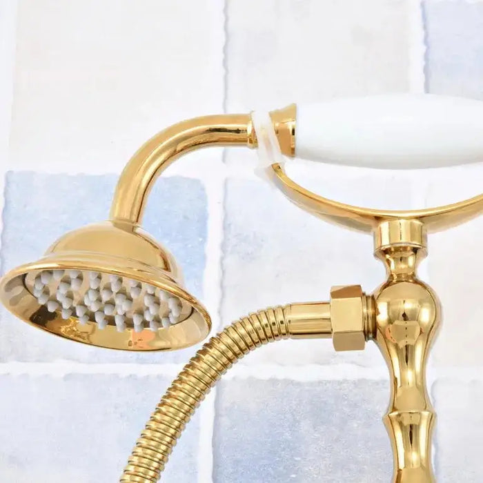 Luxury gold dual-control bathtub faucet with hand shower and ceramic valve, crafted from high-quality brass, against tiled background.