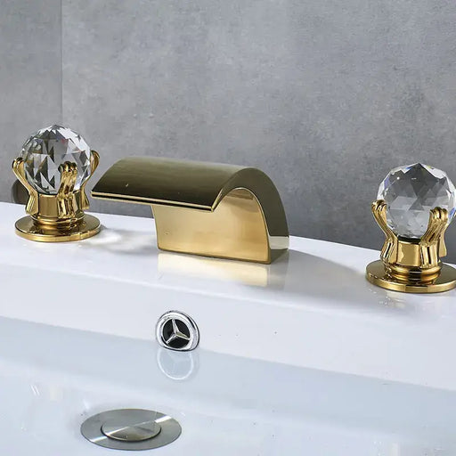 Crystal Handle Waterfall Faucet with golden finish and clear crystal knobs on a bathroom sink.