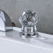 Crystal handle of a luxurious waterfall faucet with polished chrome finish, showcasing elegance and smooth water control in a bathroom setting.