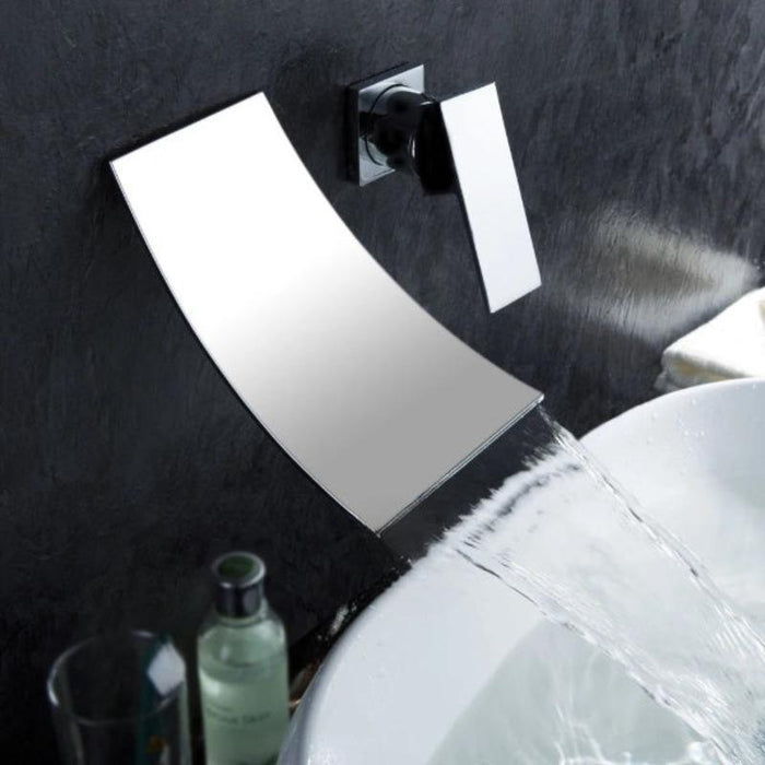 Wall-mount chrome waterfall basin faucet with sleek design and cascading water flow into basin.