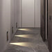 Modern indoor hallway with wall lamps illuminating the floor, showcasing advanced LED lighting suitable for walkways and stairways.