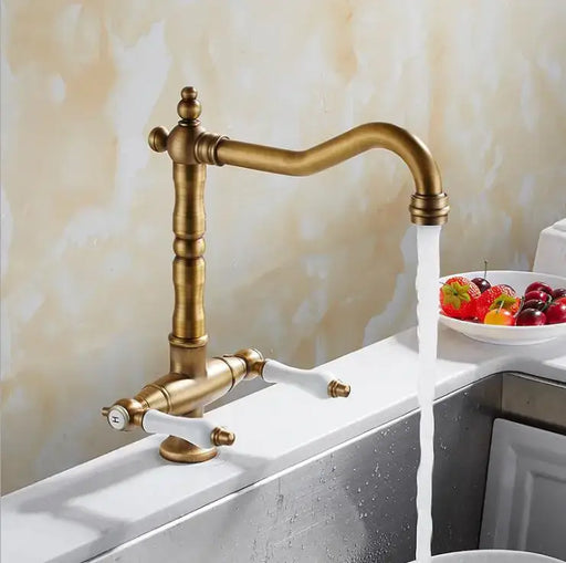 Classic brass swivel kitchen mixer tap with flowing water, featuring a vintage design and convenient 360-degree swivel spout.