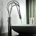 Modern LED deck-mount basin faucet with artistic flow and illuminated water feature in a contemporary bathroom setting.