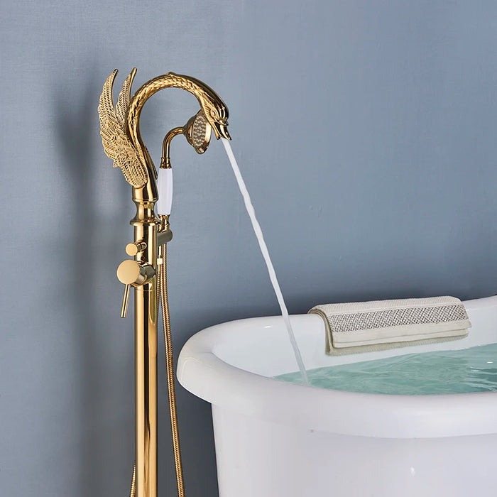 Luxury swan-style floor standing bathtub faucet in polished gold with flowing water, enhancing bathroom elegance.