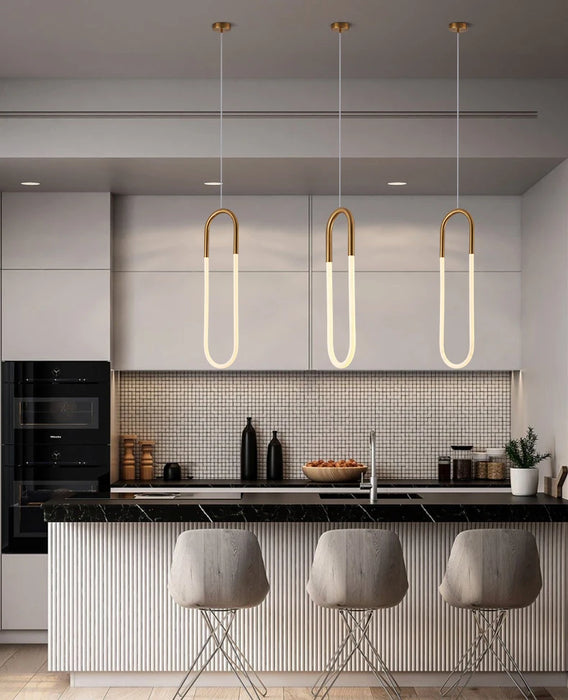 Minimalist U-shaped bar chandelier with polished chrome finish and LED bulbs in a modern kitchen setting.