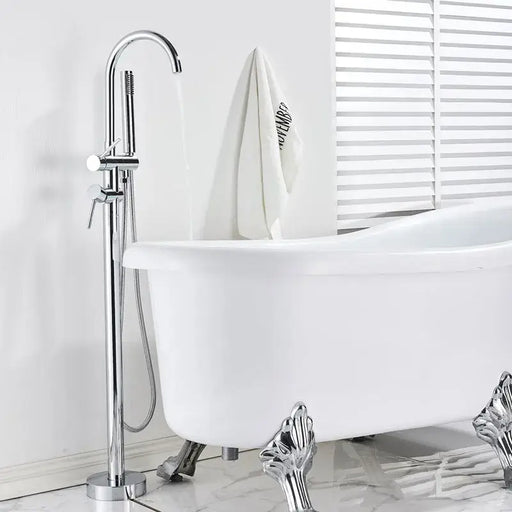 Modern swivel spout freestanding bath mixer with chrome finish next to a clawfoot bathtub in a bright bathroom.