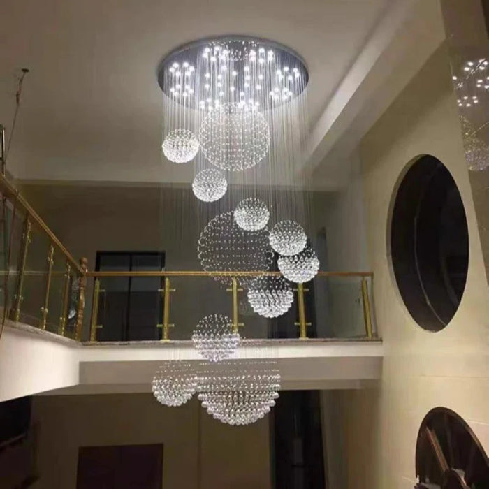 Luxury Crystal Sphere Chandelier illuminating elegant modern interior with stainless steel and crystal design.