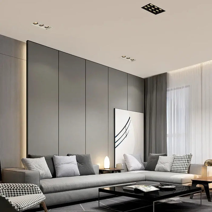 Modern living room with narrow border LED recessed downlights illuminating stylish furniture and decor.