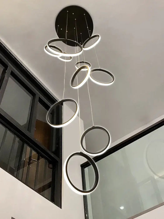 Modern LED Circular Ring Chandelier in a contemporary interior setting, featuring sleek design and multiple hanging light rings.