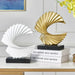 Modern Spiral Resin Sculptures in gold and white on a tabletop, elegant decorative art pieces for home or office decor.