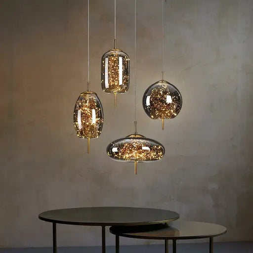 Starburst Glass Dome Pendant Lights casting warm glow over minimalist tables in cozy ambiance.