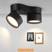 Modern black double head LED downlights illuminating wall art in a sleek, contemporary room design.