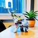 Graffiti-designed modern elephant statue on office desk with plant in background, crafted from high-quality synthetic resin.