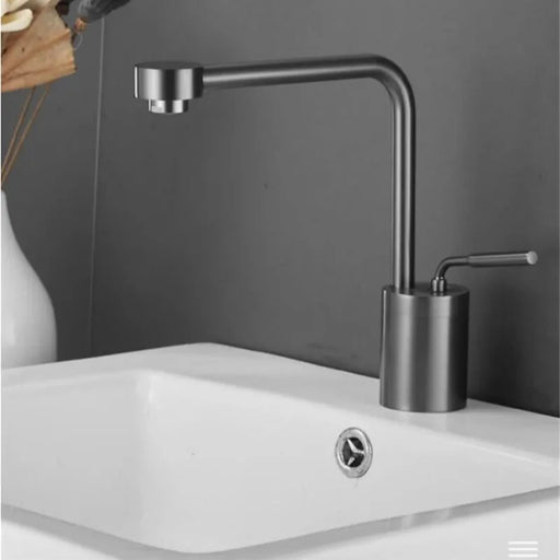 Swivel Arm Deck-Mount Basin Faucet with sleek rotary arm and single-handle design installed on a white sink.